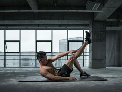 An empty, minimalist training space with a yoga mat and natural light.